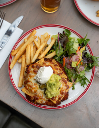 MEXICAN PARMA 33 chicken schnitzel, corn chips, napoli, salami, jalapeños, mozzarella, avocado, sour cream, steak fries, dressed leaves